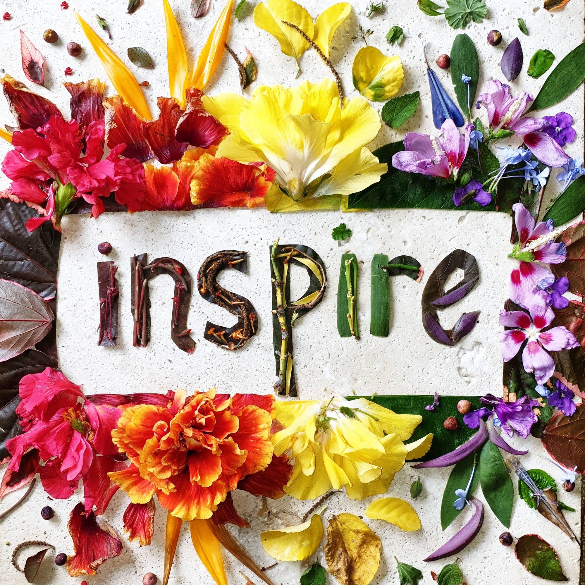 Creative word art made with flowers on stone table