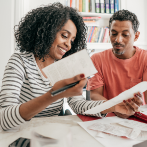 A man and a woman looking at receipts