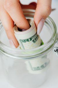 person holding rolled banknotes