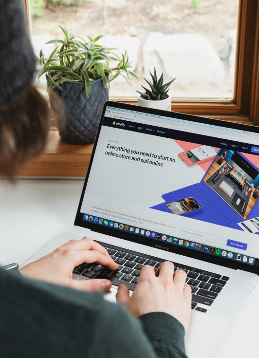 shopify logo on a laptop. mistakes to avoid when starting a shopify store